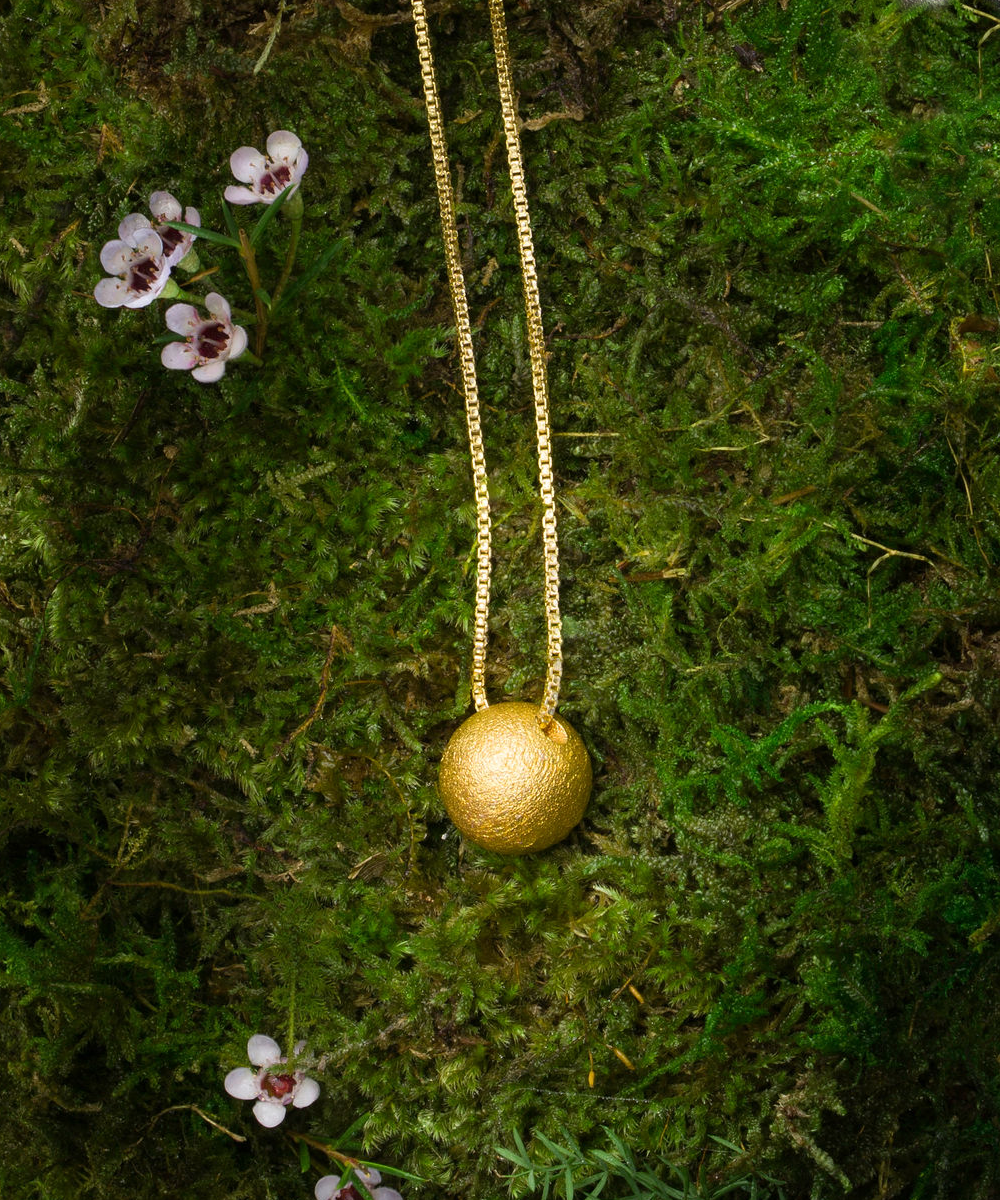 Gold Alloy Soul Sphere Necklace on moss