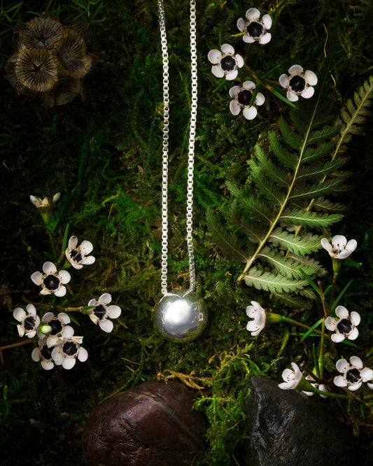Solid Sterling Silver Soul Sphere Necklace on flowers